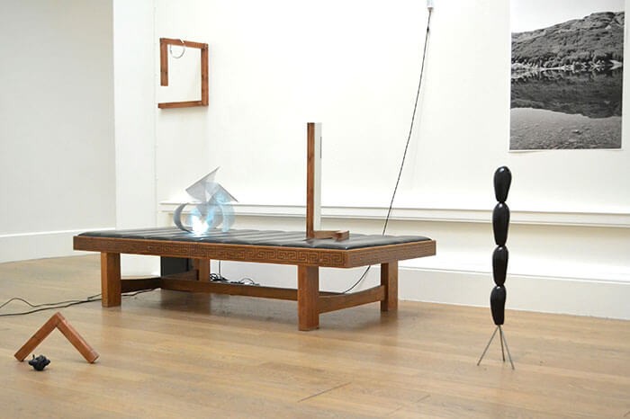 alexander_millar_wave_2013_installation_view_metal_wood_leather_lights_aubergines_mirror_looped_video_print_2